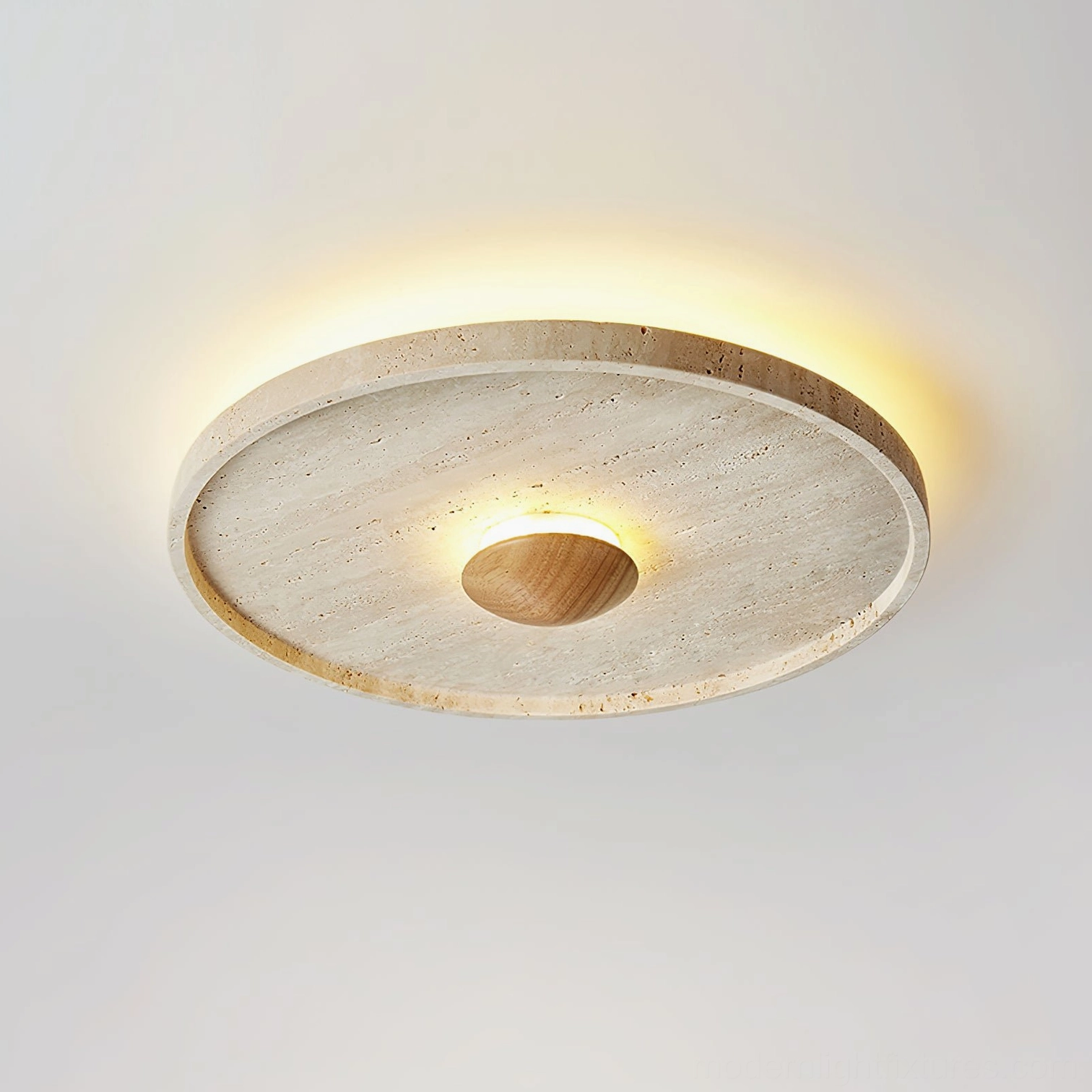 Modern travertine flush mount ceiling fixture with warm ambient glow, angled overhead view