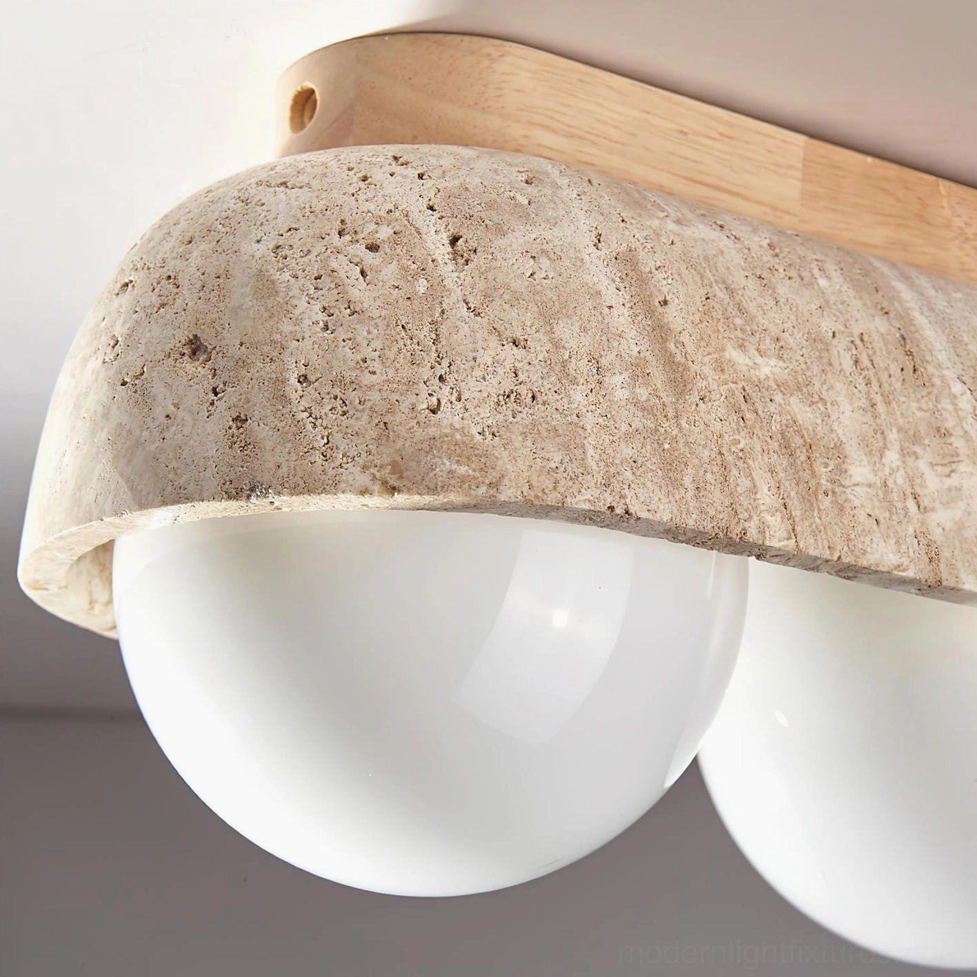 Travertine ceiling light fixture mounted in spa-like bathroom or wellness space with soft illumination