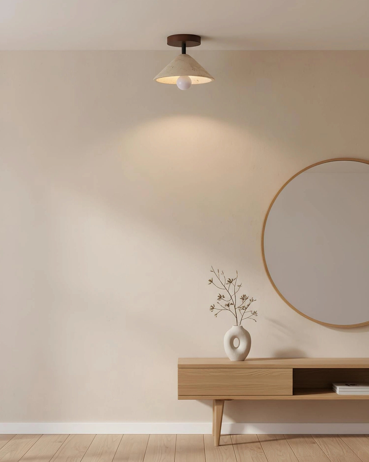 Sierra travertine ceiling light installed in minimalist entryway with console table and round mirror