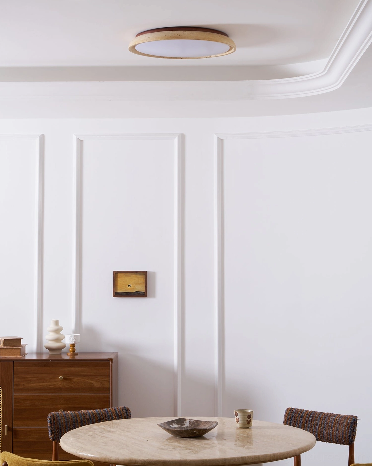 Piedra travertine ceiling light creating architectural focal point in contemporary hallway space