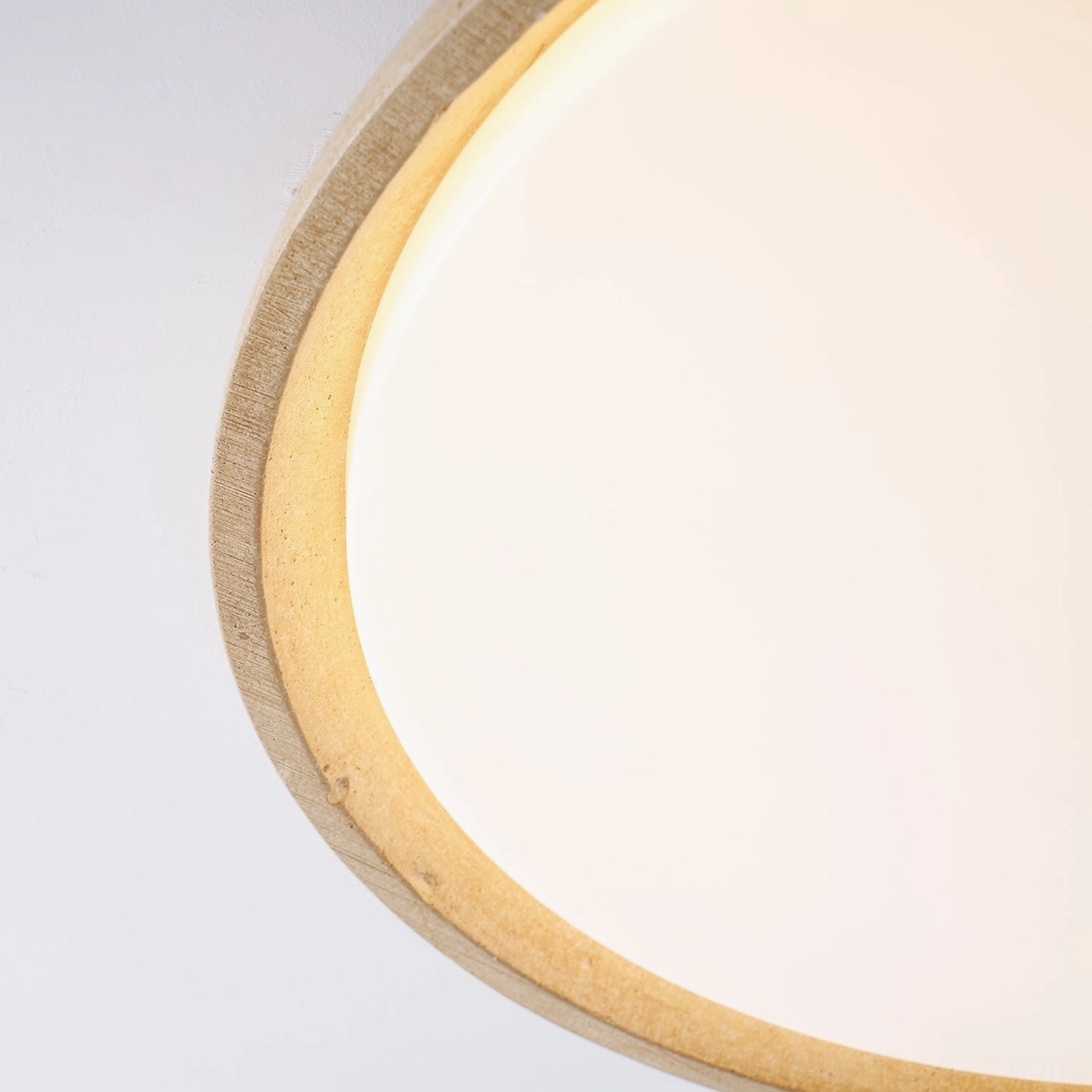 Travertine ceiling light with warm 3000K LED glow creating serene ambient atmosphere