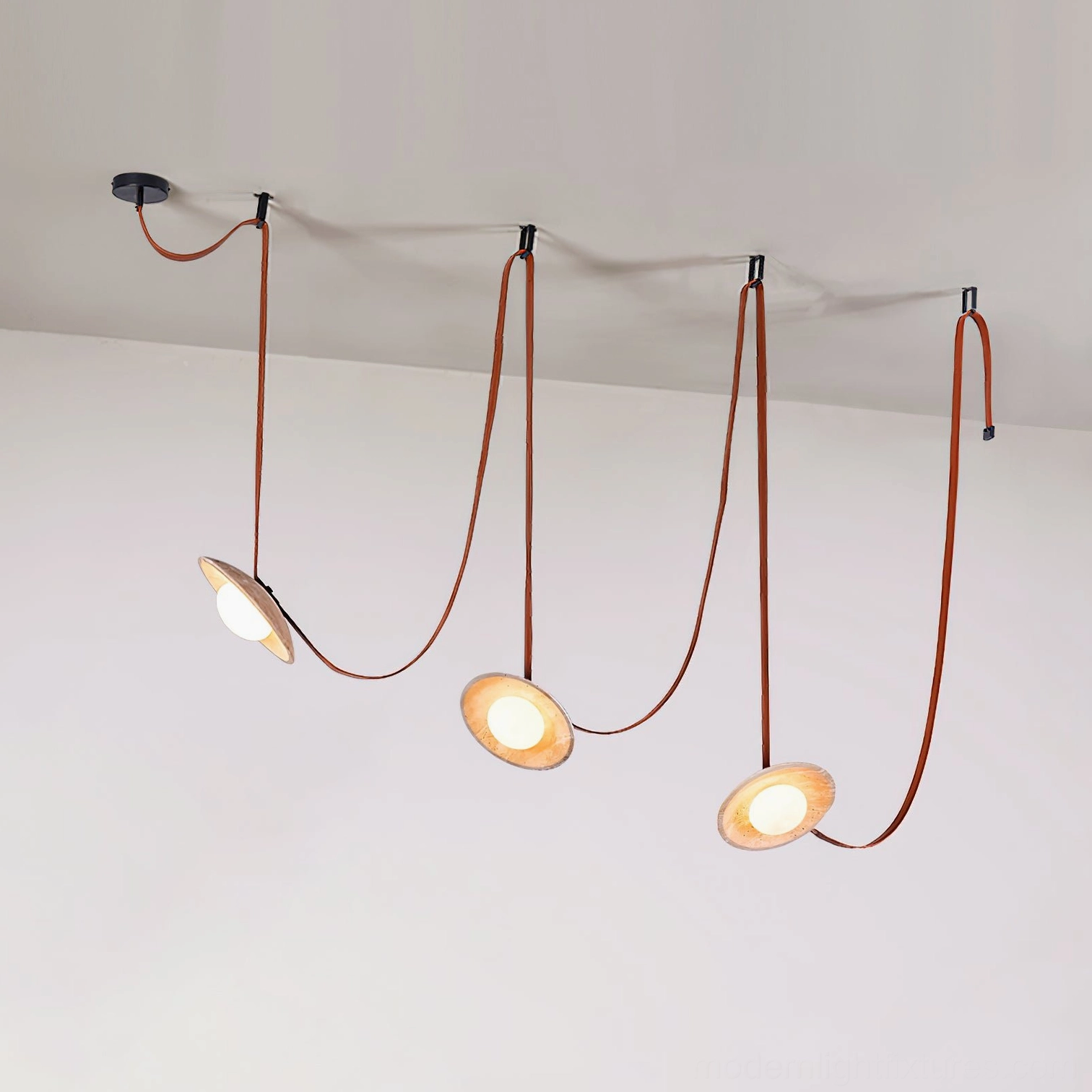 Travertine chandelier lighting design featuring dual pendant heads with warm amber glow and leather suspension