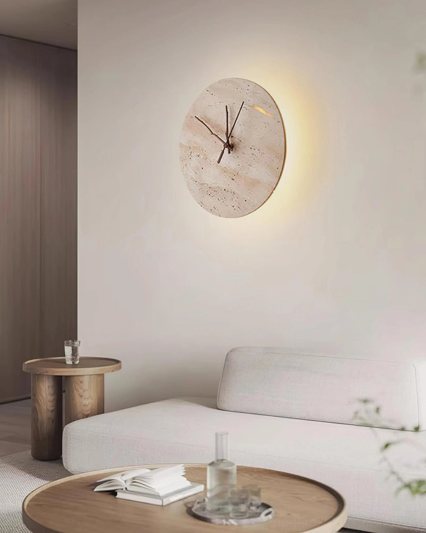 Travertine clock wall sconce showcasing dark wood clock hands and warm backlighting design