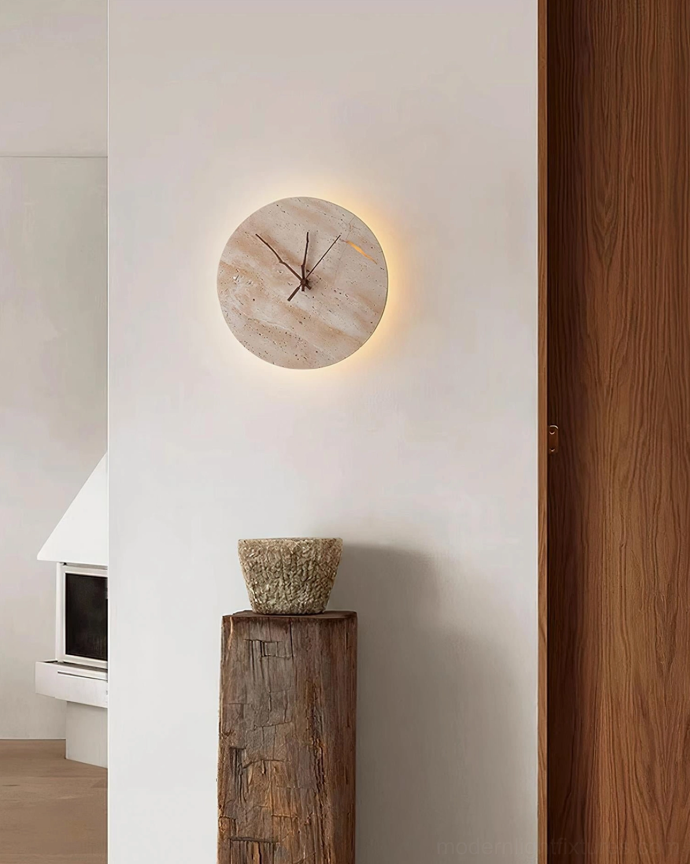 Travertine clock wall sconce mounted in modern interior creating warm ambient architectural accent