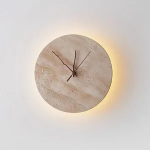 Beige travertine clock wall lamp with warm LED backlighting creating ambient glow effect