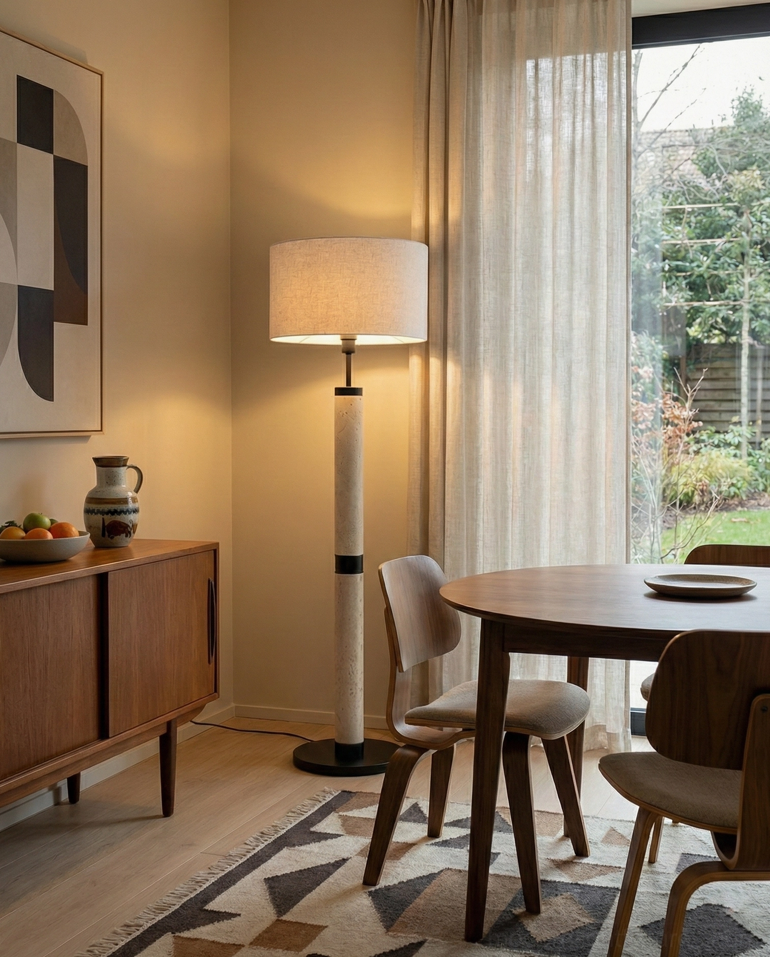 Architectural travertine column floor lamp in dining area - warm ambient lighting for residential space