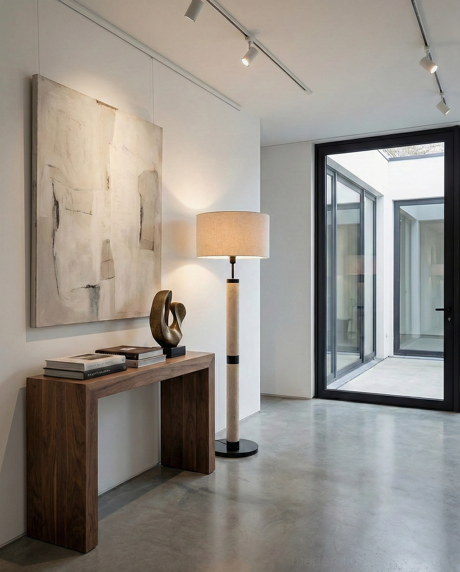 Travertine column floor lamp in contemporary entryway beside console table with wall art - modern foyer lighting