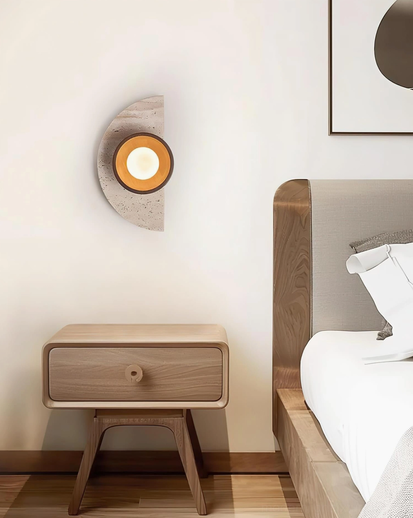 Modern wall sconce with natural stone base and frosted glass sphere creating warm ambient lighting effect