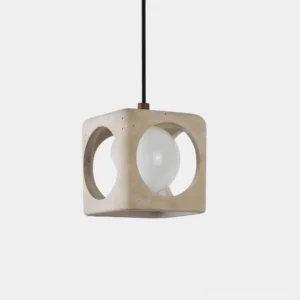 Hollowa travertine geometric pendant light with hollow-cube design and illuminated glass bulb, front studio view
