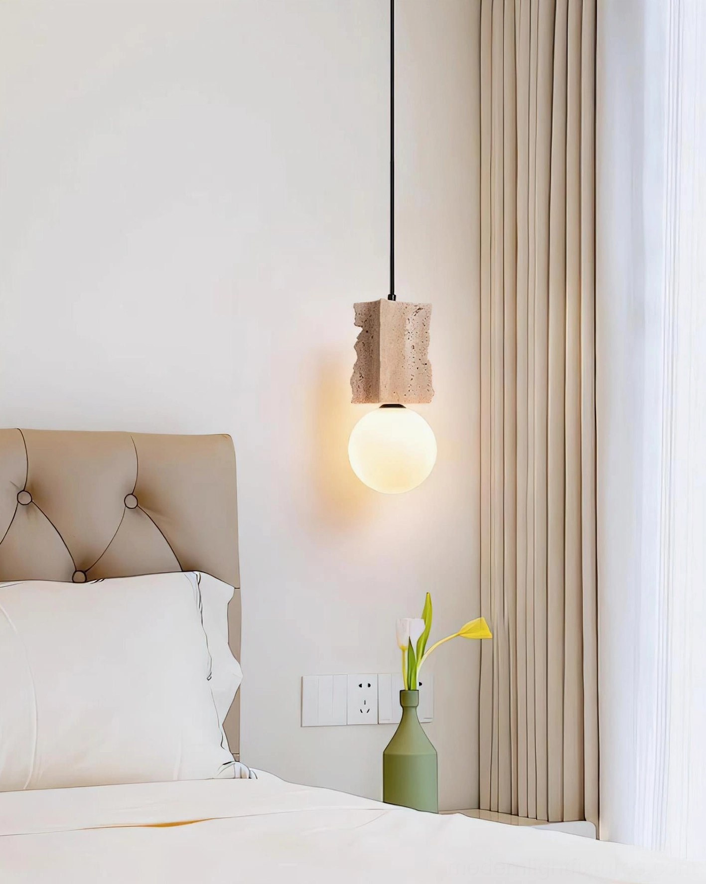 Travertine globe pendant suspended in bedroom corner demonstrating wabi-sabi aesthetic with neutral warm minimalist bedroom decor