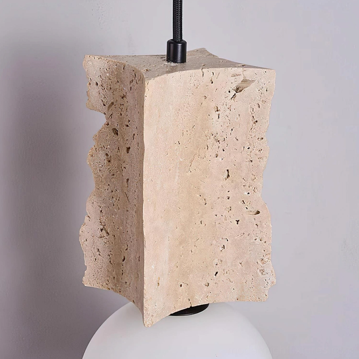 Travertine pendant light in living space demonstrating how organic modern sculpture-like fixture enhances contemporary home decor
