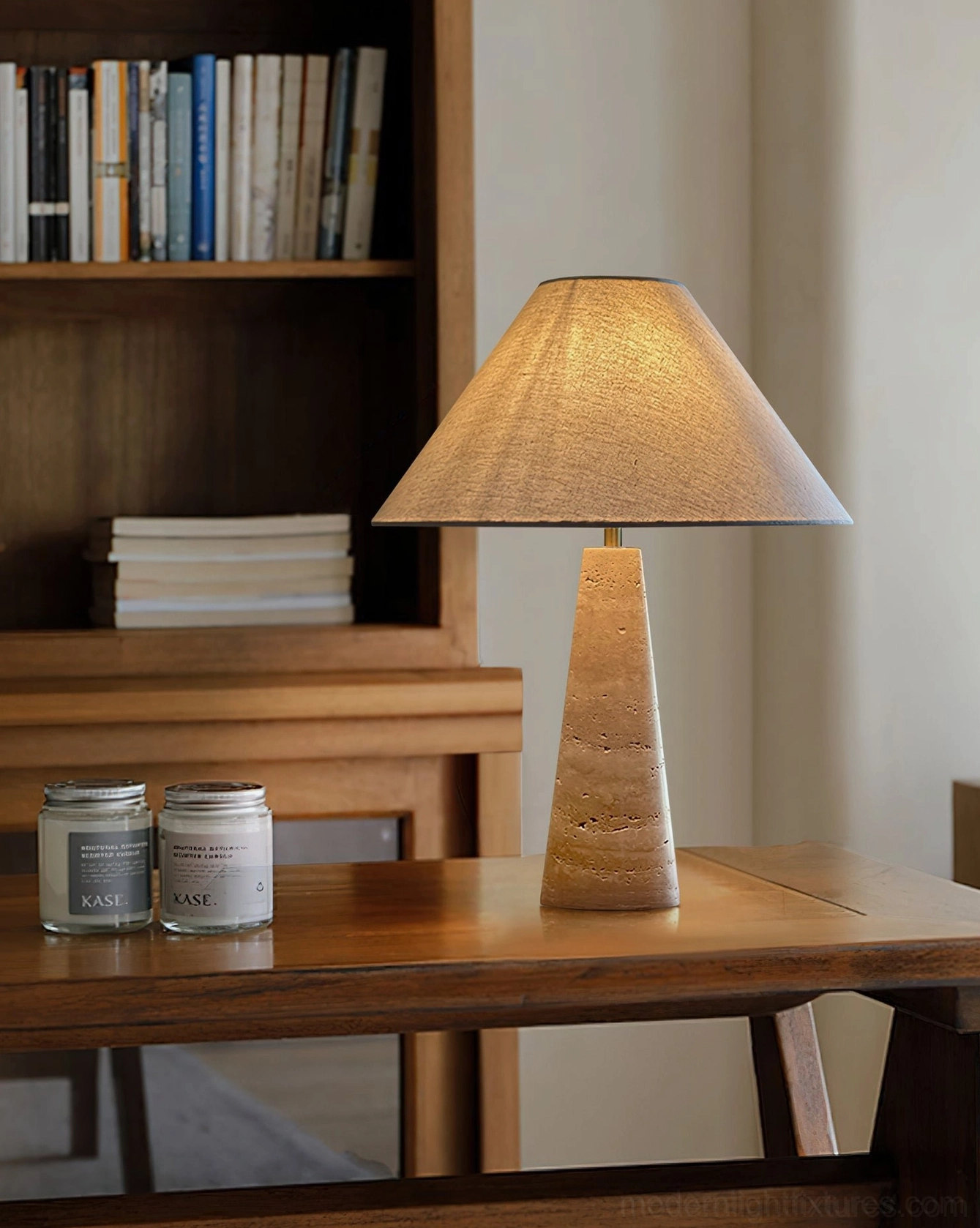 Natural stone travertine table lamp in warm beige positioned in contemporary minimalist interior setting with neutral palette