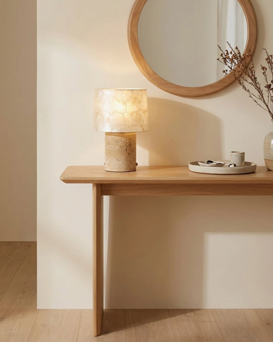 Natural stone table lamp on entryway console table with wall mirror and dried botanicals