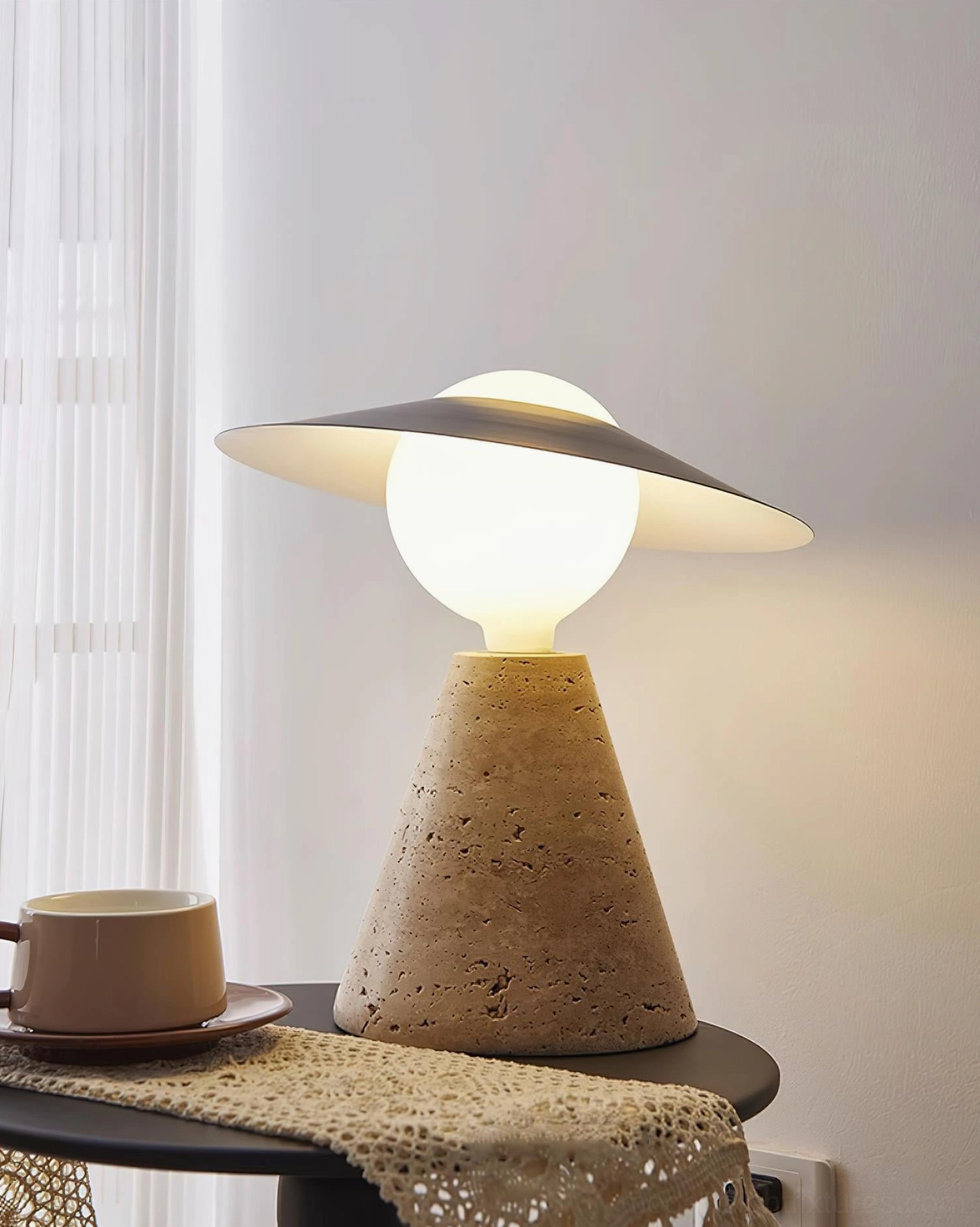 Modern travertine table lamp creating layered lighting ambiance