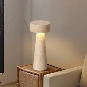 Travertine stone table lamp styled on rattan side table in living room corner with warm neutral home decor