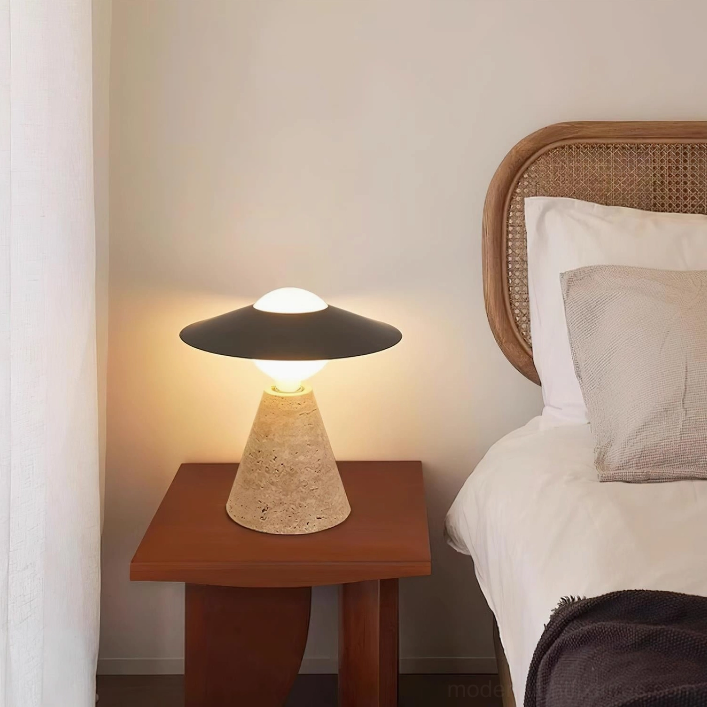 Minimalist travertine table lamp with metal shade next to wooden nightstand