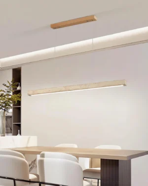 Modern travertine pendant chandelier above wooden dining table warm natural lighting