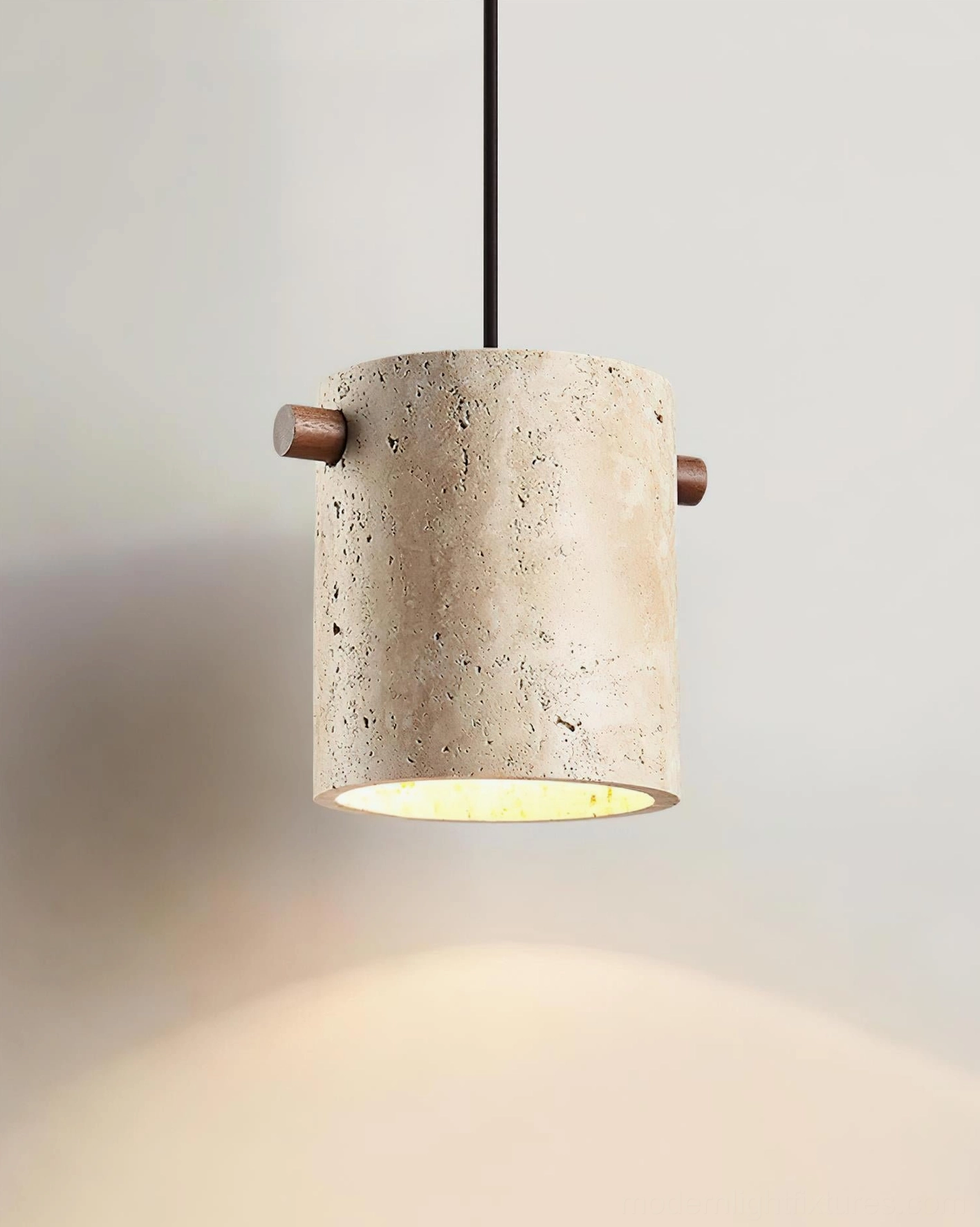 Single travertine pendant lamp in bedroom or accent space, warm ambient lighting with minimalist design
