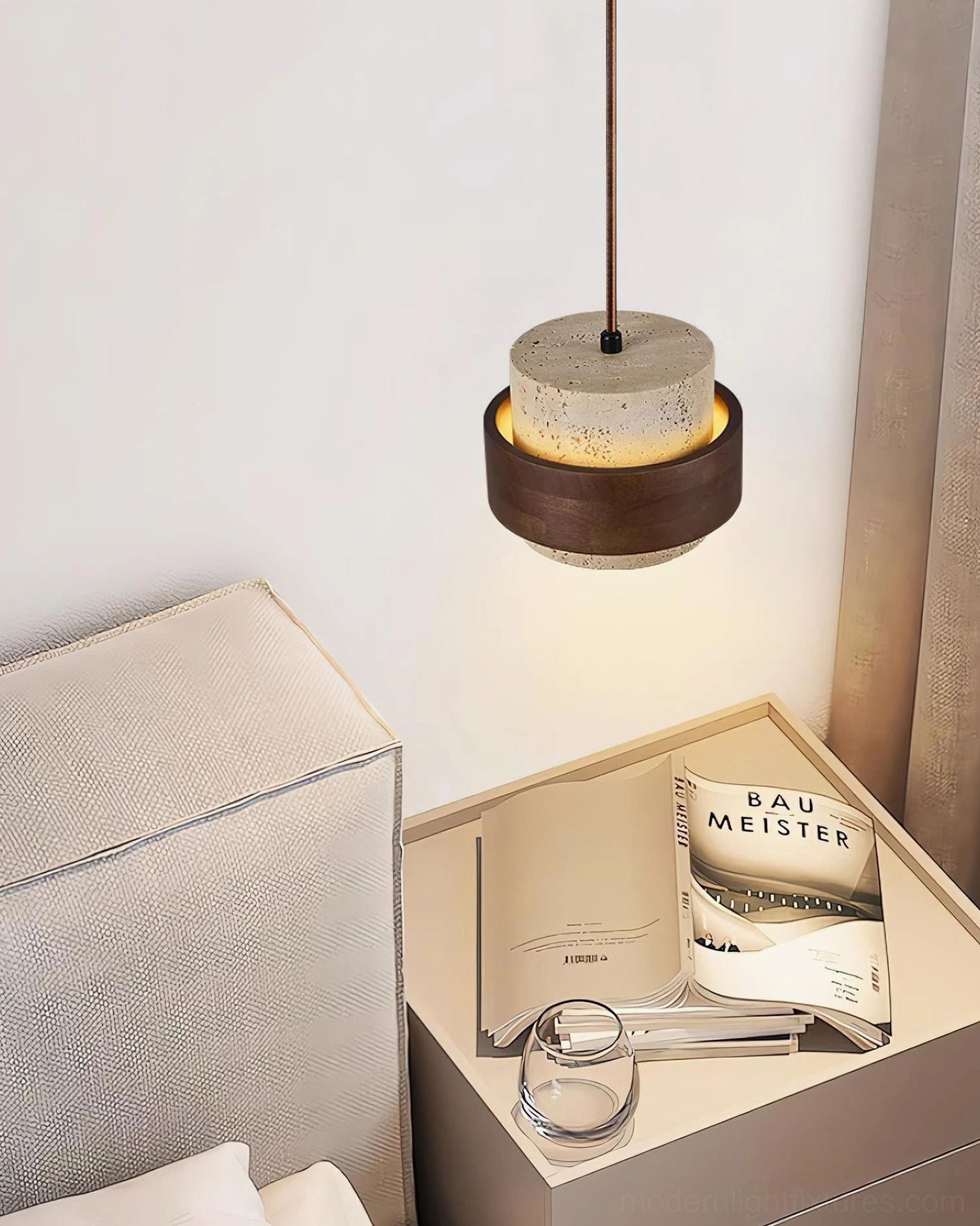 Travertine pendant bedside lamp in minimalist bedroom nook, placed next to upholstered furniture, cozy wabi-sabi interior styling
