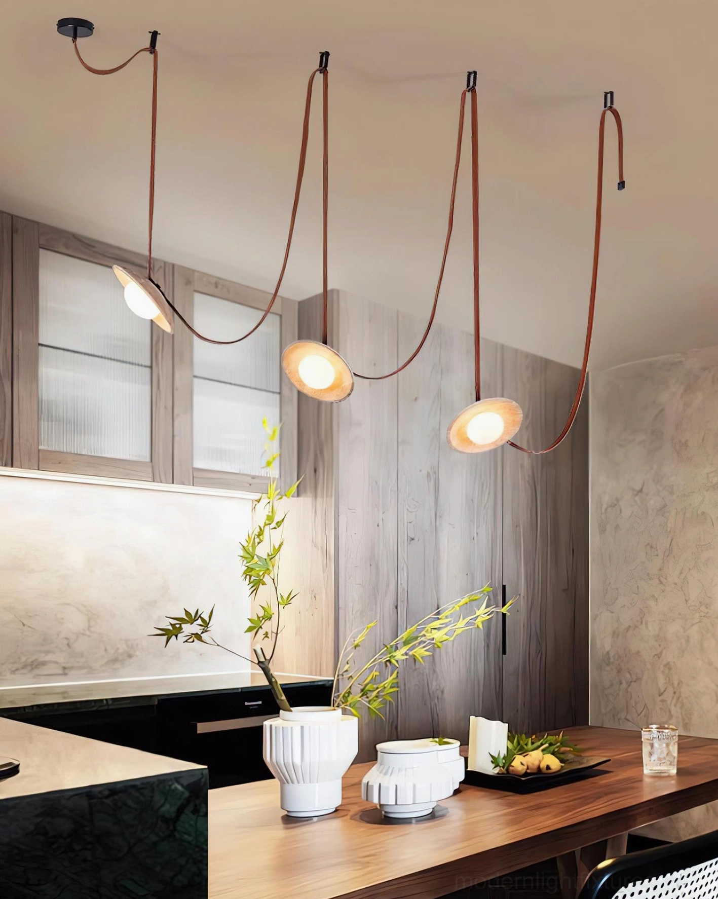 Contemporary travertine pendant chandelier above kitchen island, front view with warm lighting and wooden counter