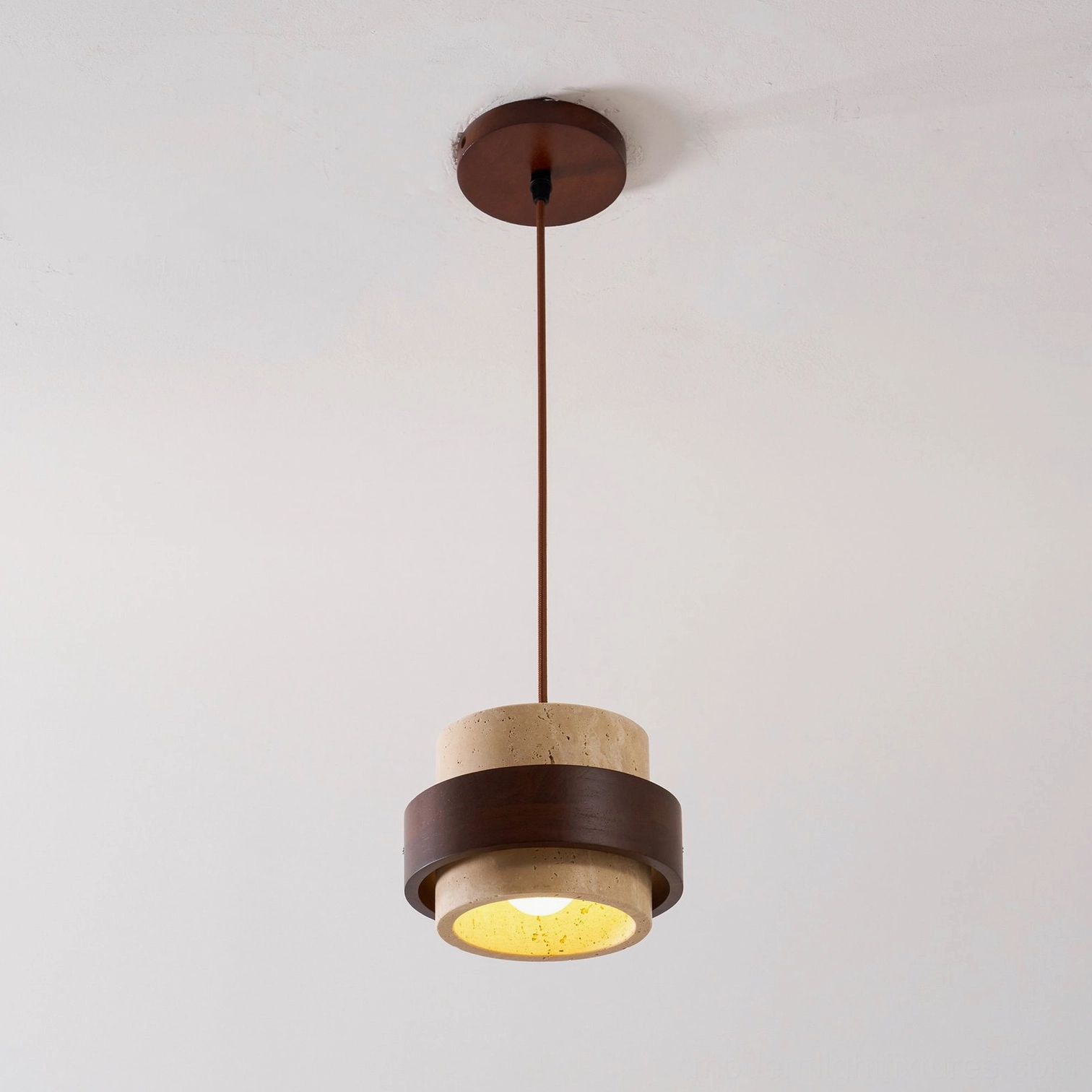 Travertine pendant lamp architectural lighting in minimalist modern interior, focal point suspended fixture