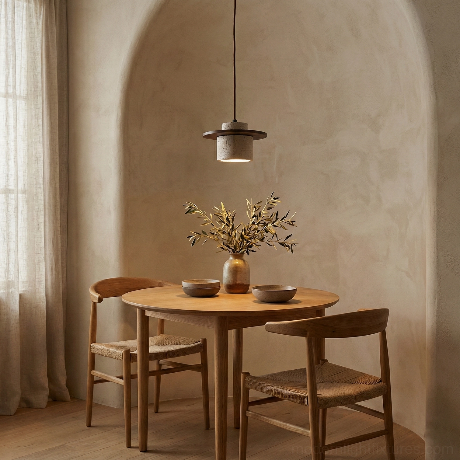 Travertine pendant lamp creating warm ambient light in cozy dining nook with stucco wall and wooden round table
