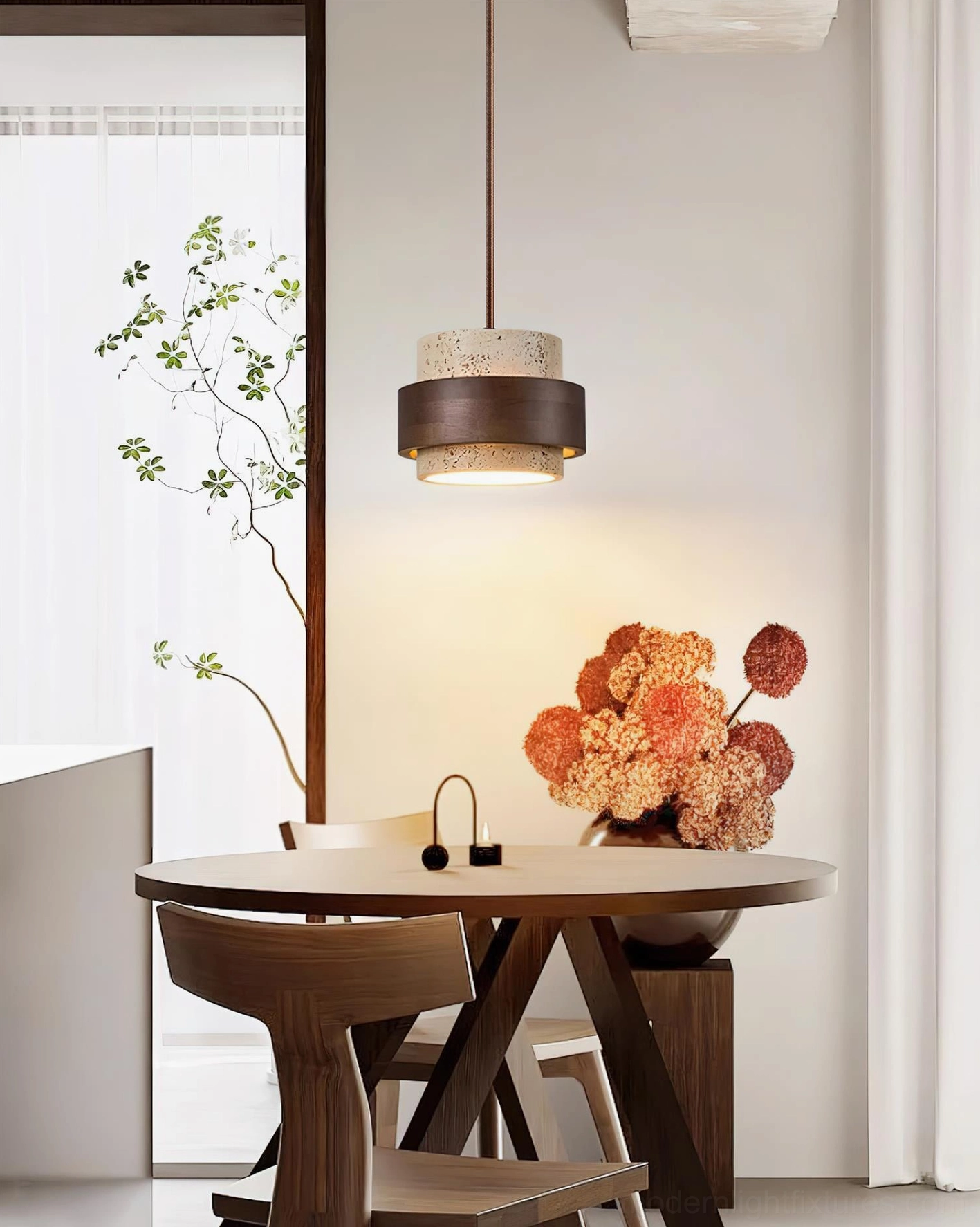 Travertine stone pendant lamp hanging over japandi dining table with flower centerpiece, ambient lighting demonstration in home interior