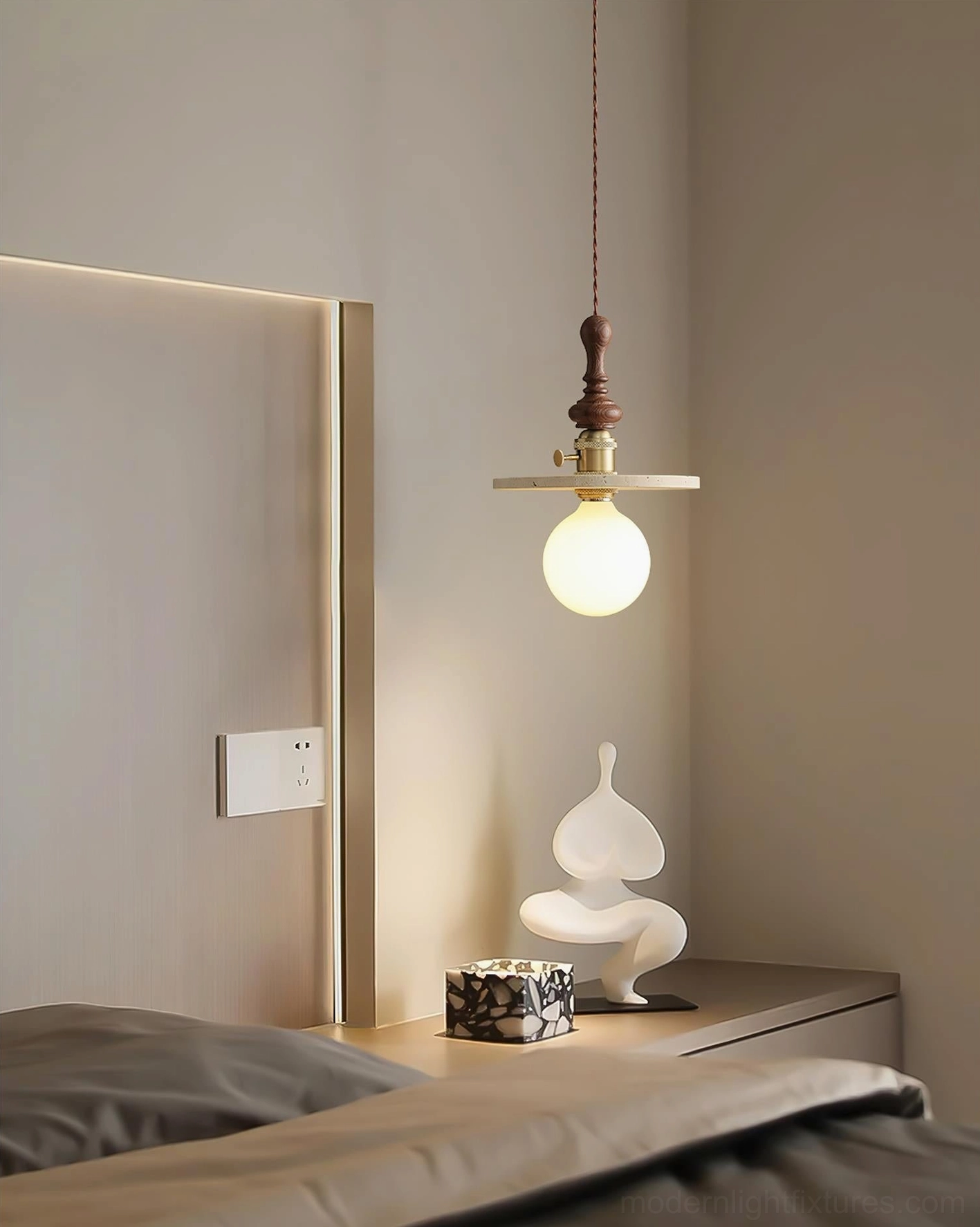 Travertine pendant light illuminated in minimalist bedroom side view
