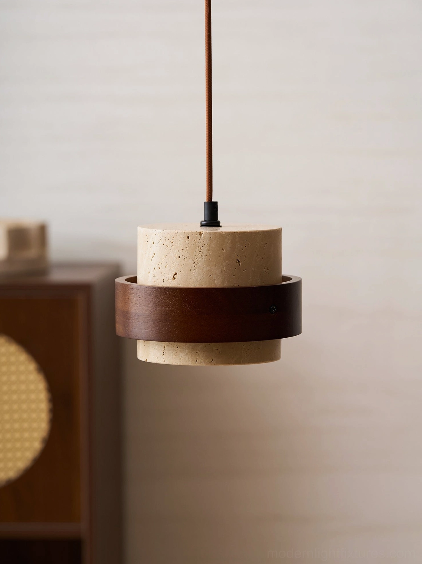 Travertine pendant light fixture demonstrating warm interior glow through porous stone material, illuminated from inside
