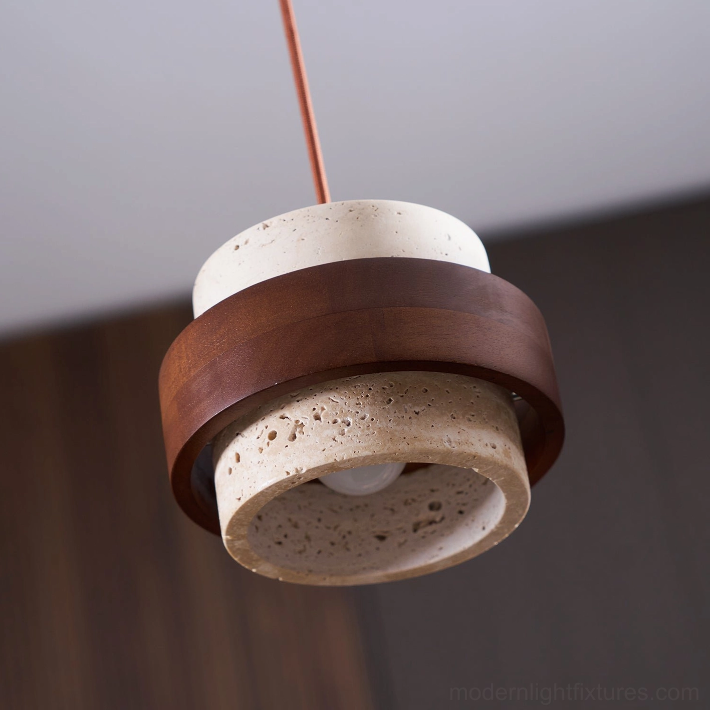 Travertine pendant lamp installation detail with electrical connections and hanging hardware visible