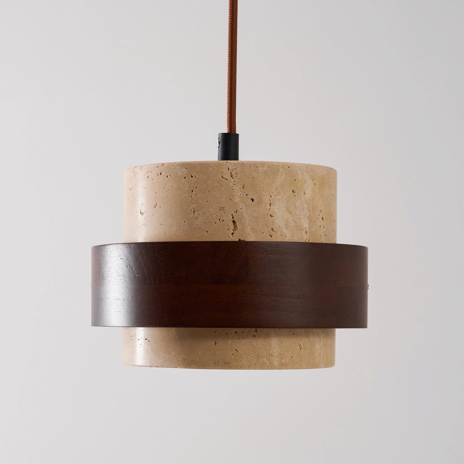 Travertine pendant lamp warm interior glow photography, capturing light diffusion through porous stone material