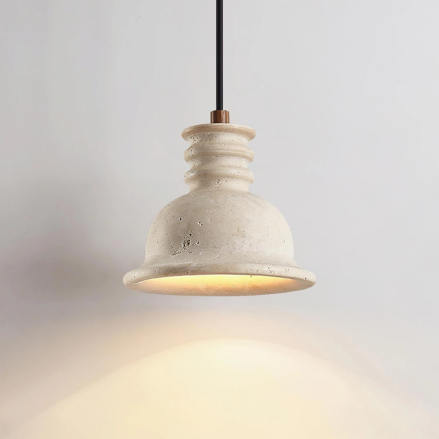 Travertine pendant light side view showcasing warm stone texture and wood accent detail with soft downward lighting effect