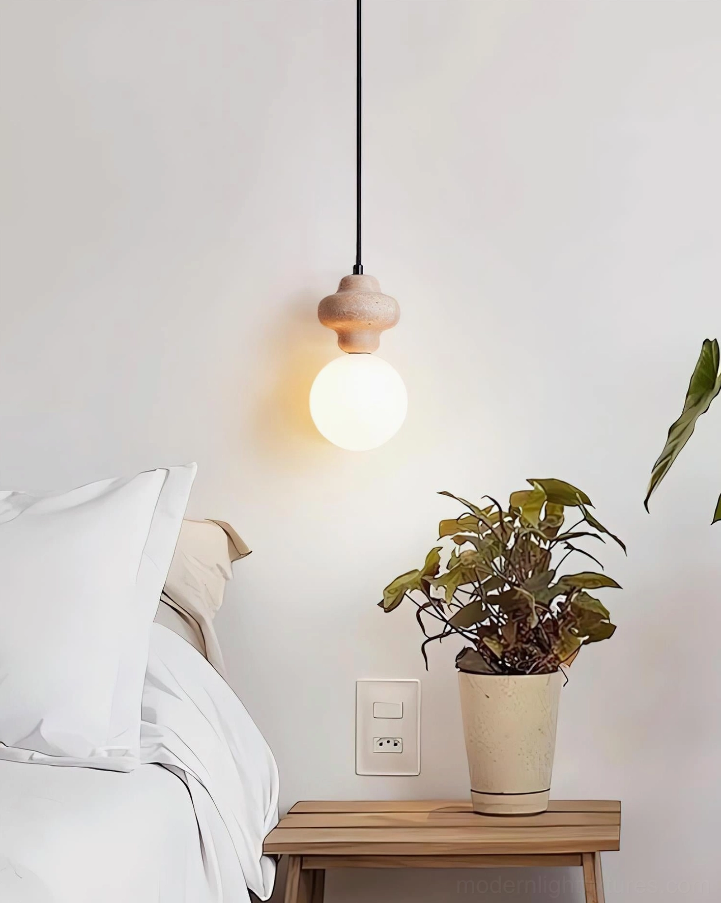 Cenari travertine pendant light with frosted glass globe providing warm ambient illumination in modern home setting