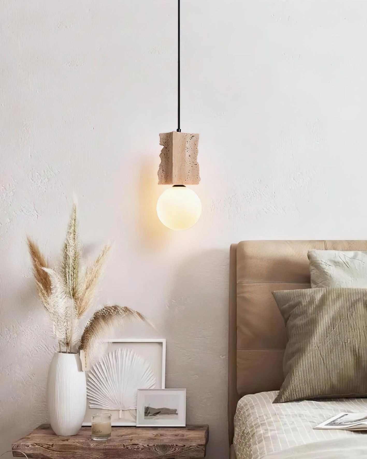 Travertine pendant light installed above bedroom nightstand creating warm ambient bedroom lighting in minimalist interior design