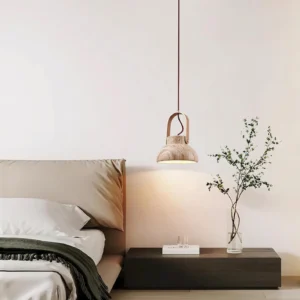 Modern travertine pendant light above bedroom nightstand, warm minimalist Scandinavian bedroom lighting