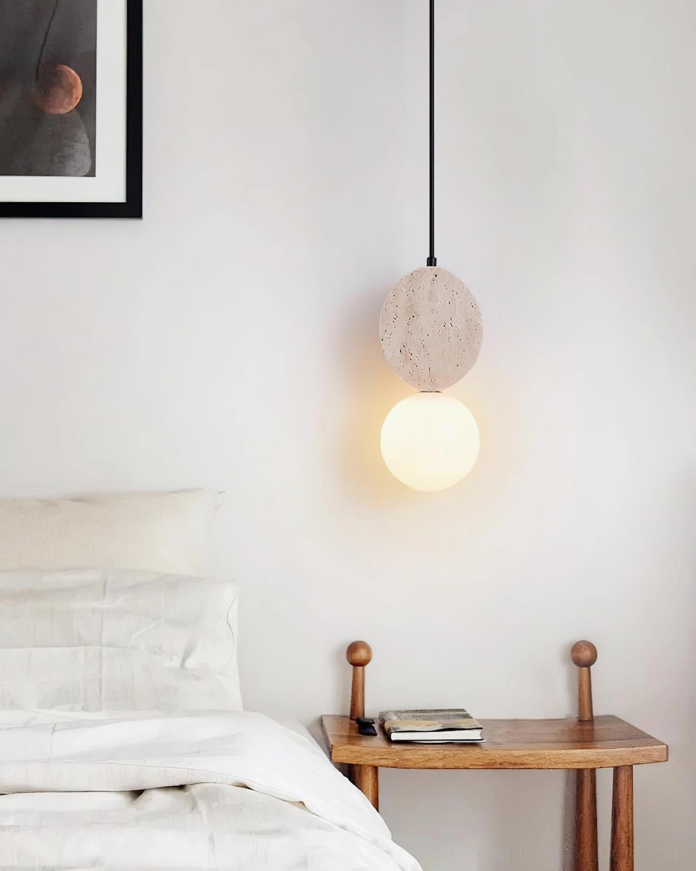 Cenari pendant lamp installed in contemporary bedroom with round travertine stone base and illuminated frosted glass globe