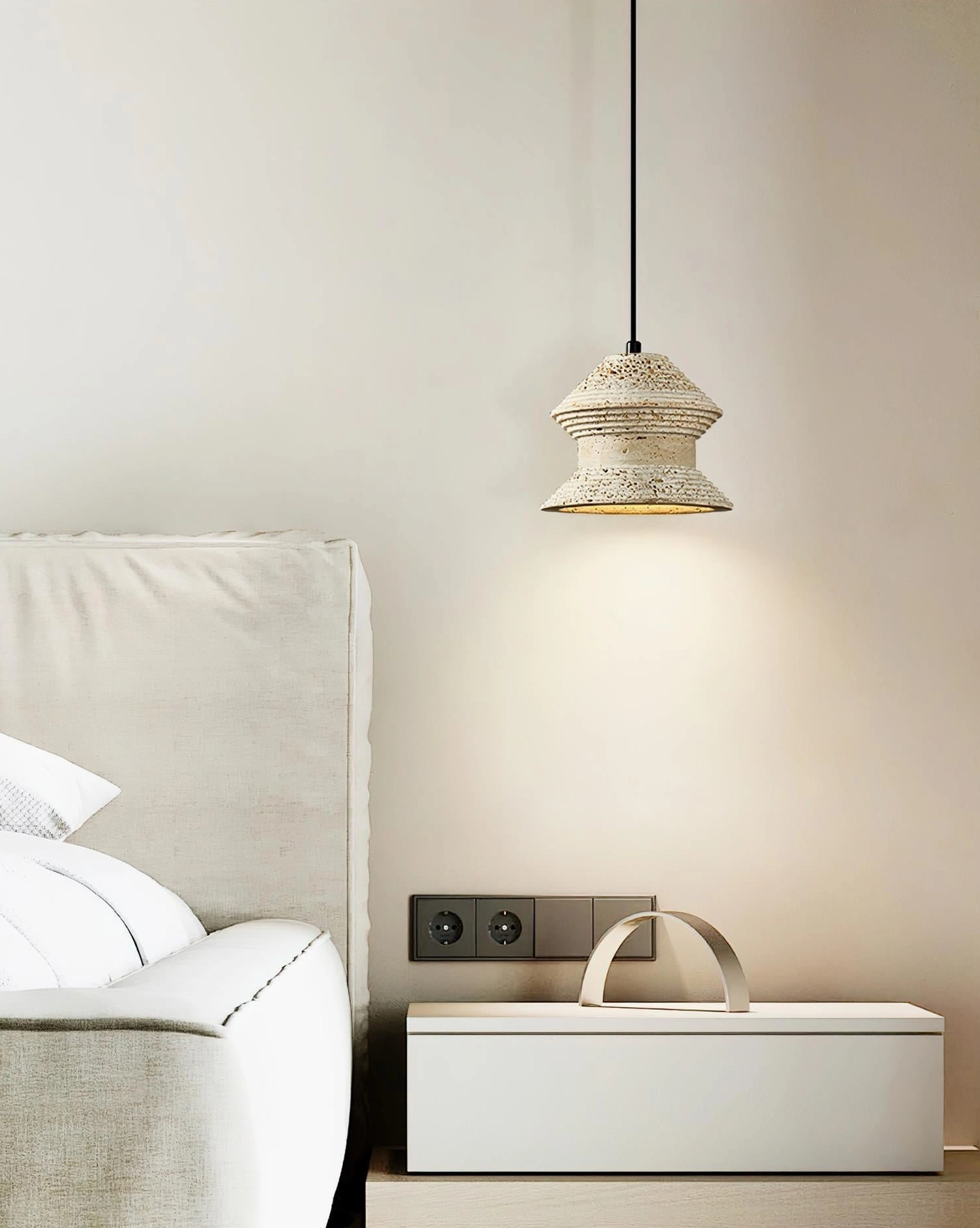 Single travertine pendant lamp installed in bedroom providing warm ambient lighting above nightstand