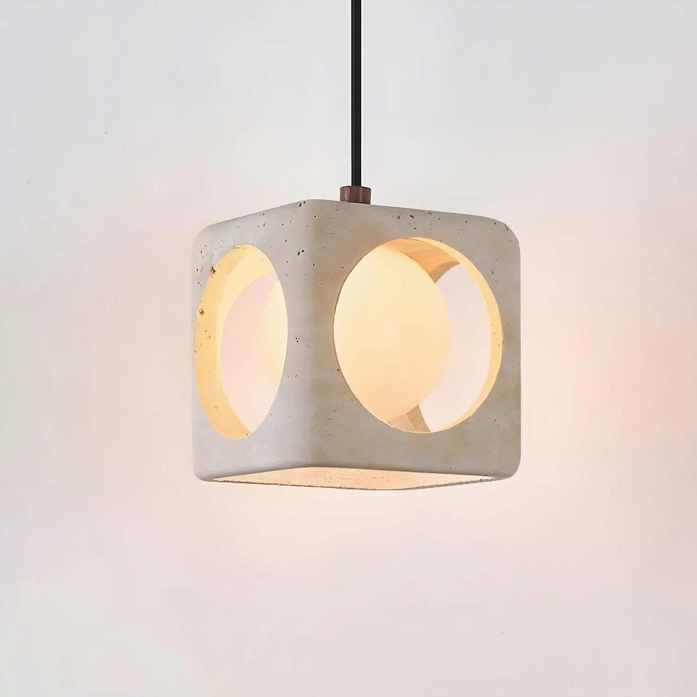 Close-up of Hollowa travertine pendant lamp showing warm ambient light and detailed hollow arch cuts