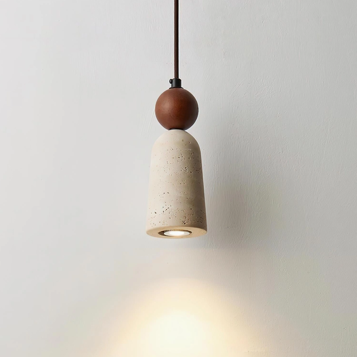 Studio product shot of Bellin travertine pendant light showing complete fixture design and proportions
