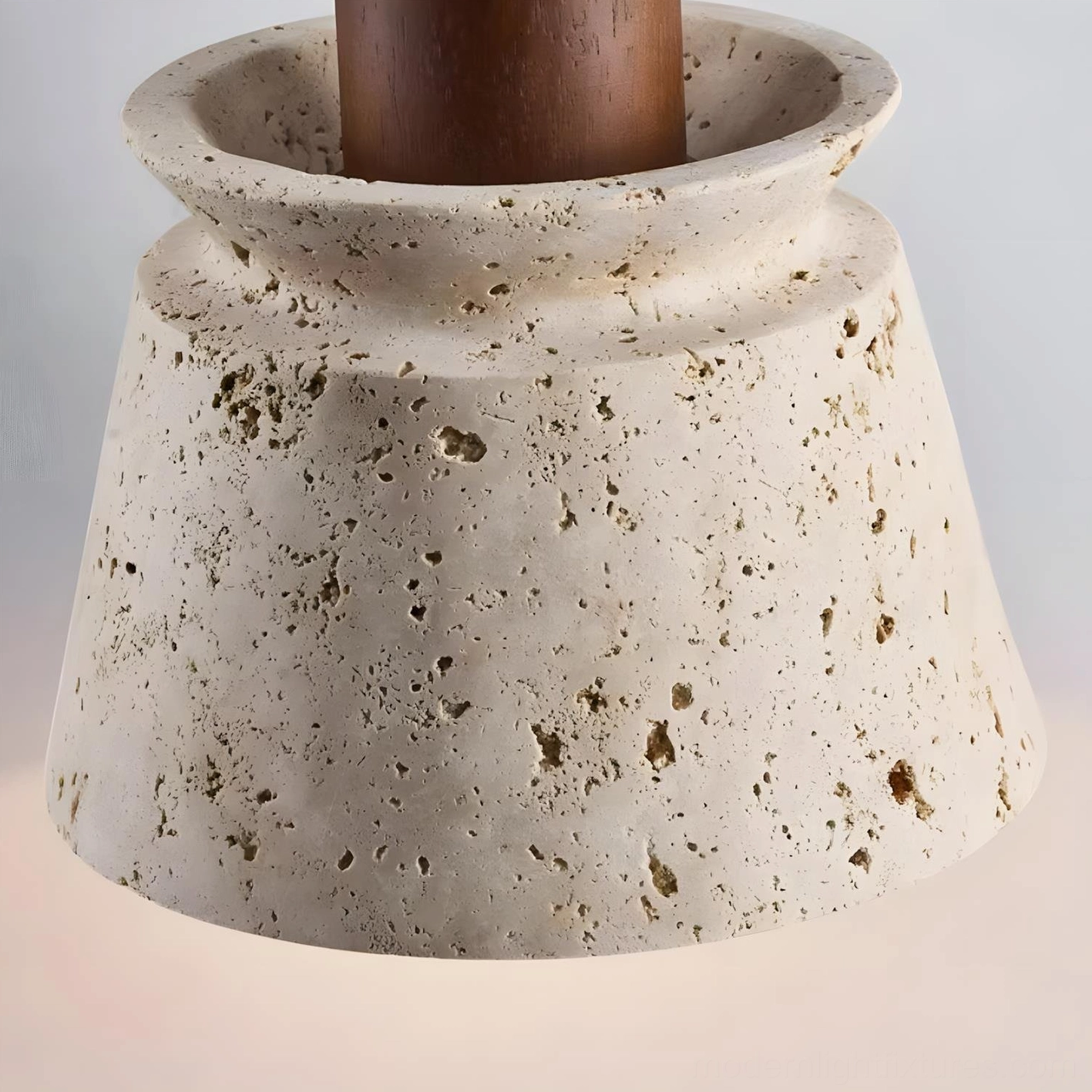 Contemporary dining space styled with travertine pendant light demonstrating interior design coordination and placement