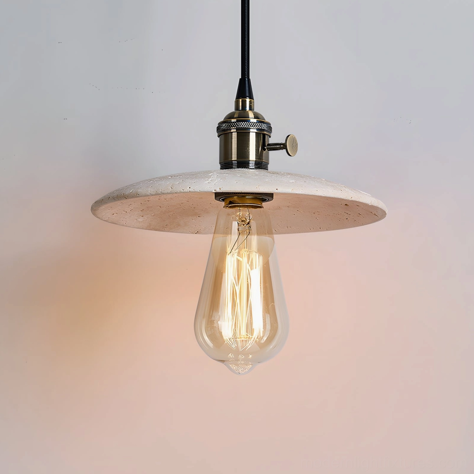 Natural travertine stone pendant light with exposed filament bulb and brass metal fitting detail