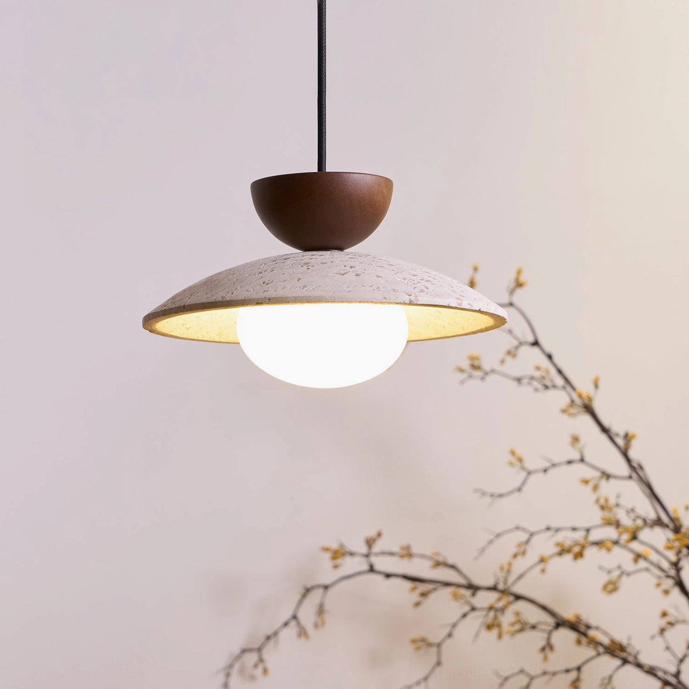 Tia travertine pendant light suspended in contemporary dining room with warm ambiance