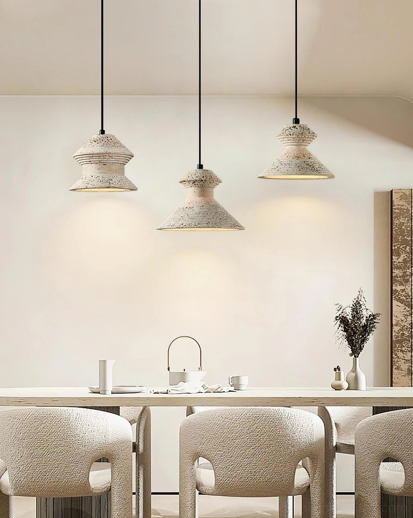 Travertine pendant light fixture hanging above modern dining room table in contemporary home interior