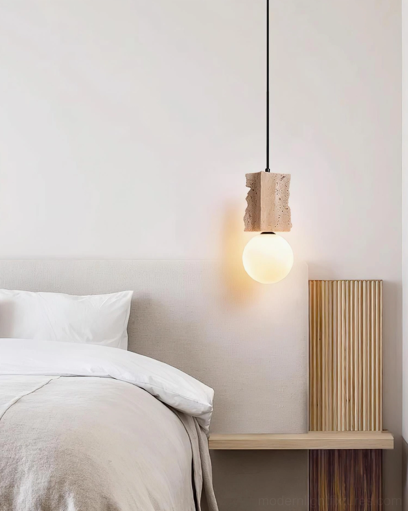 Studio shot of travertine globe pendant illuminated showing warm ambient light output and frosted glass diffusion quality