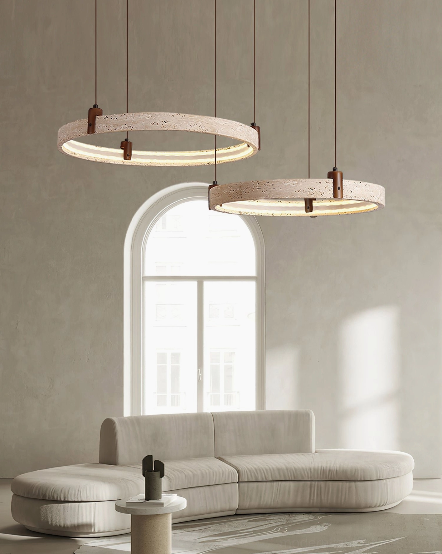 Eclora travertine ring chandelier in wabi-sabi living room with arched window and curved sofa