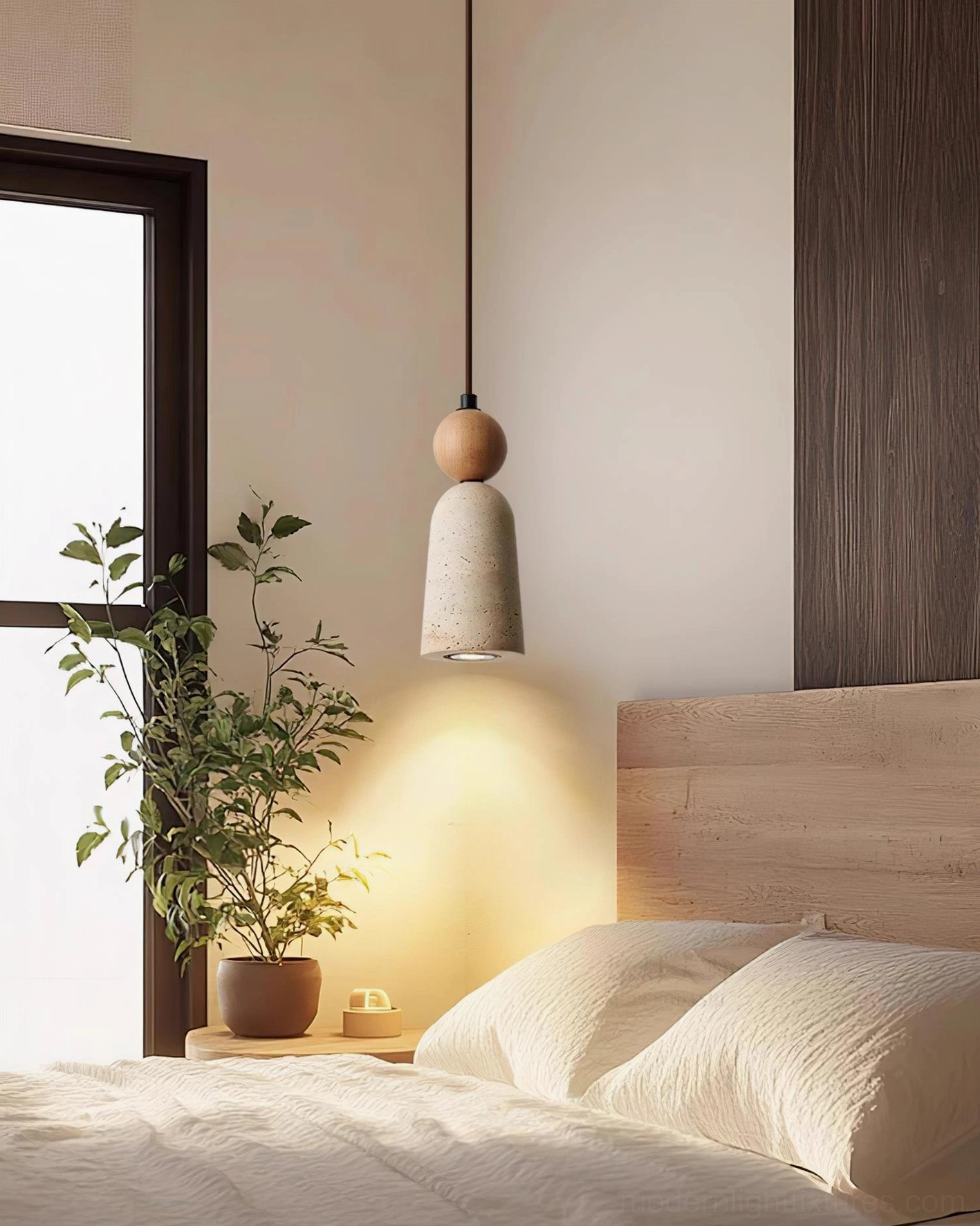 Bellin travertine pendant light installed in modern bedroom with natural wood nightstand and plant decoration