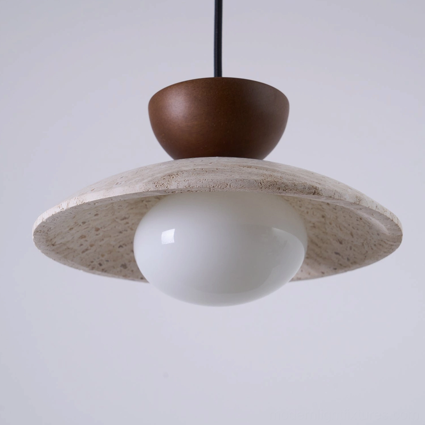 Tia travertine pendant lamp above minimalist dining table in modern home interior