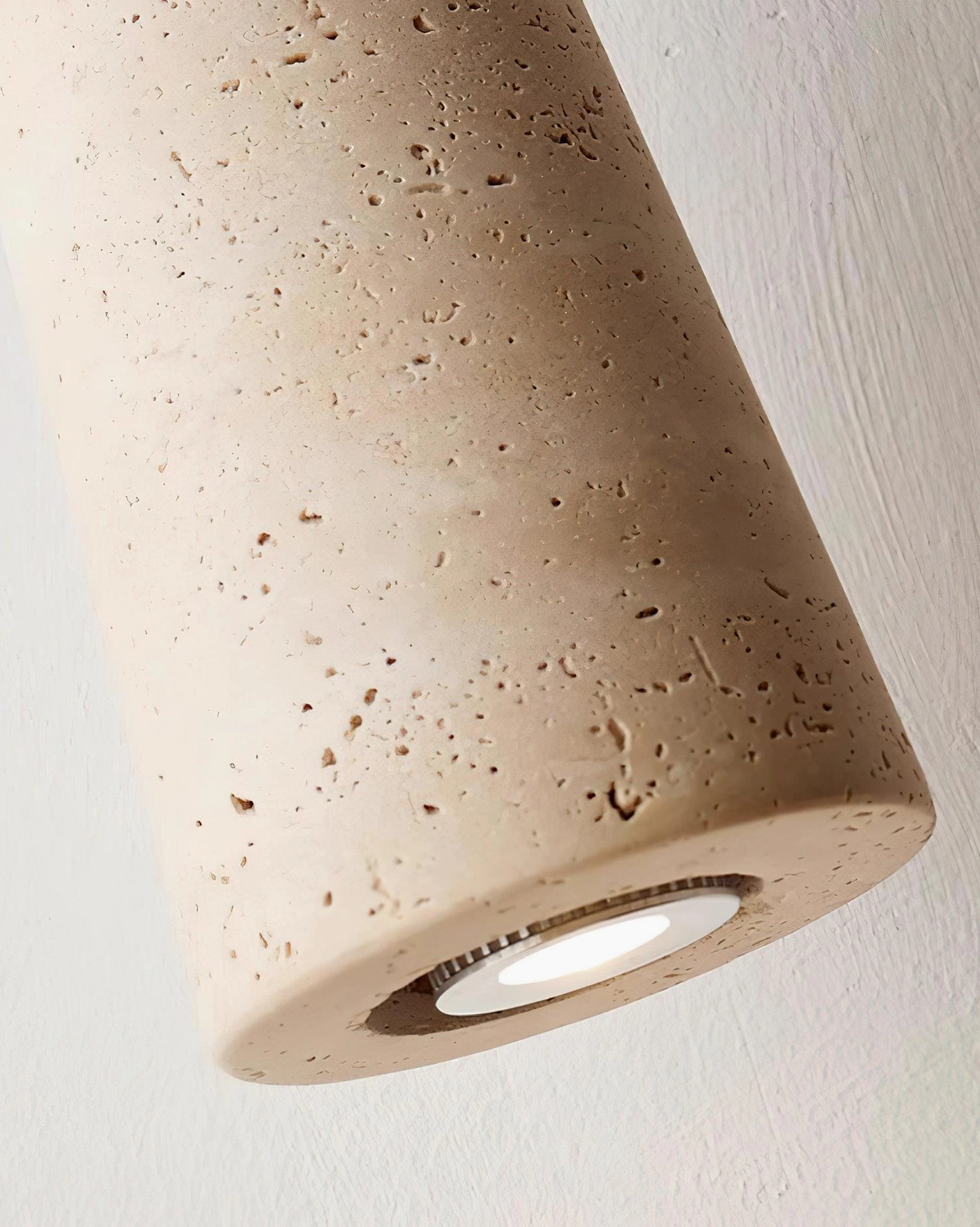 Multiple angle view of Bellin travertine pendant light fixture showing sculptural form and material composition