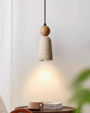 Overhead view of Bellin pendant lamp with natural wood accent illuminating side table in bedroom corner
