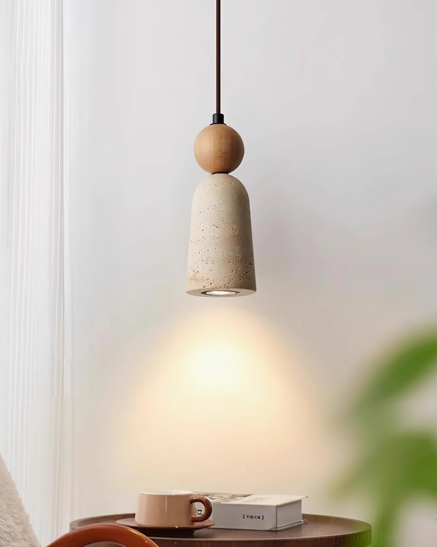 Overhead view of Bellin pendant lamp with natural wood accent illuminating side table in bedroom corner
